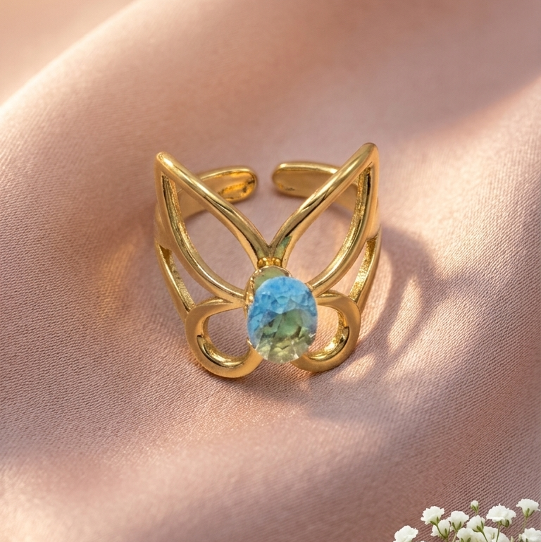 butterfly-shaped ring with a central blue