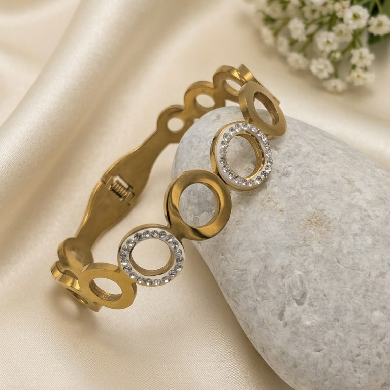 Gold bangle kada with three circular links set with clear stones