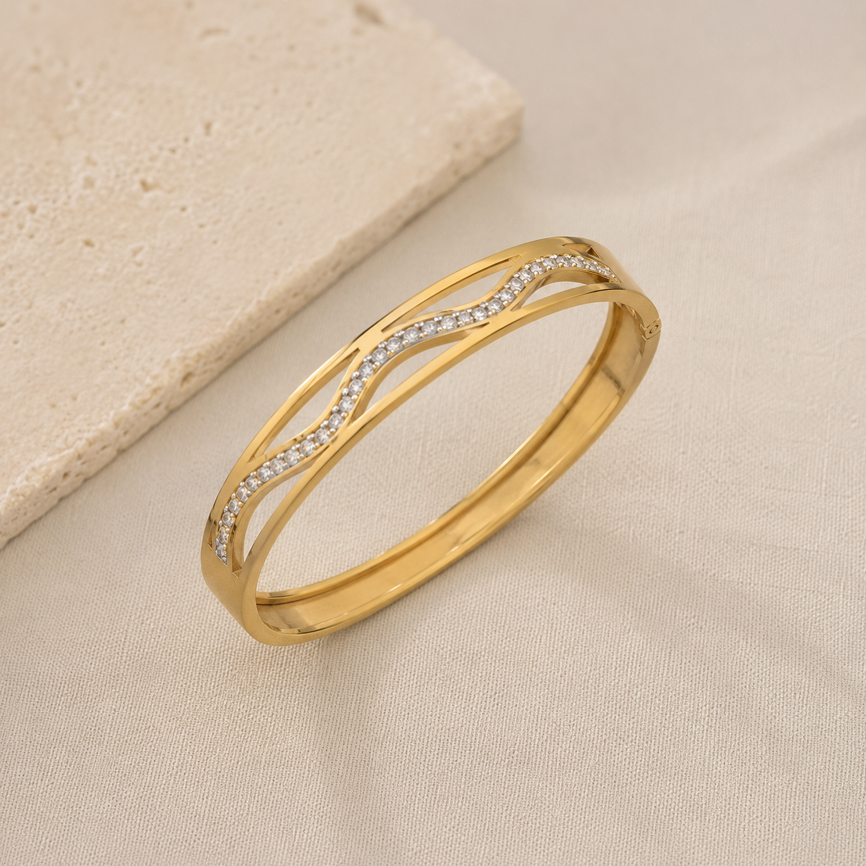 Gold bangle bracelet with embedded stones