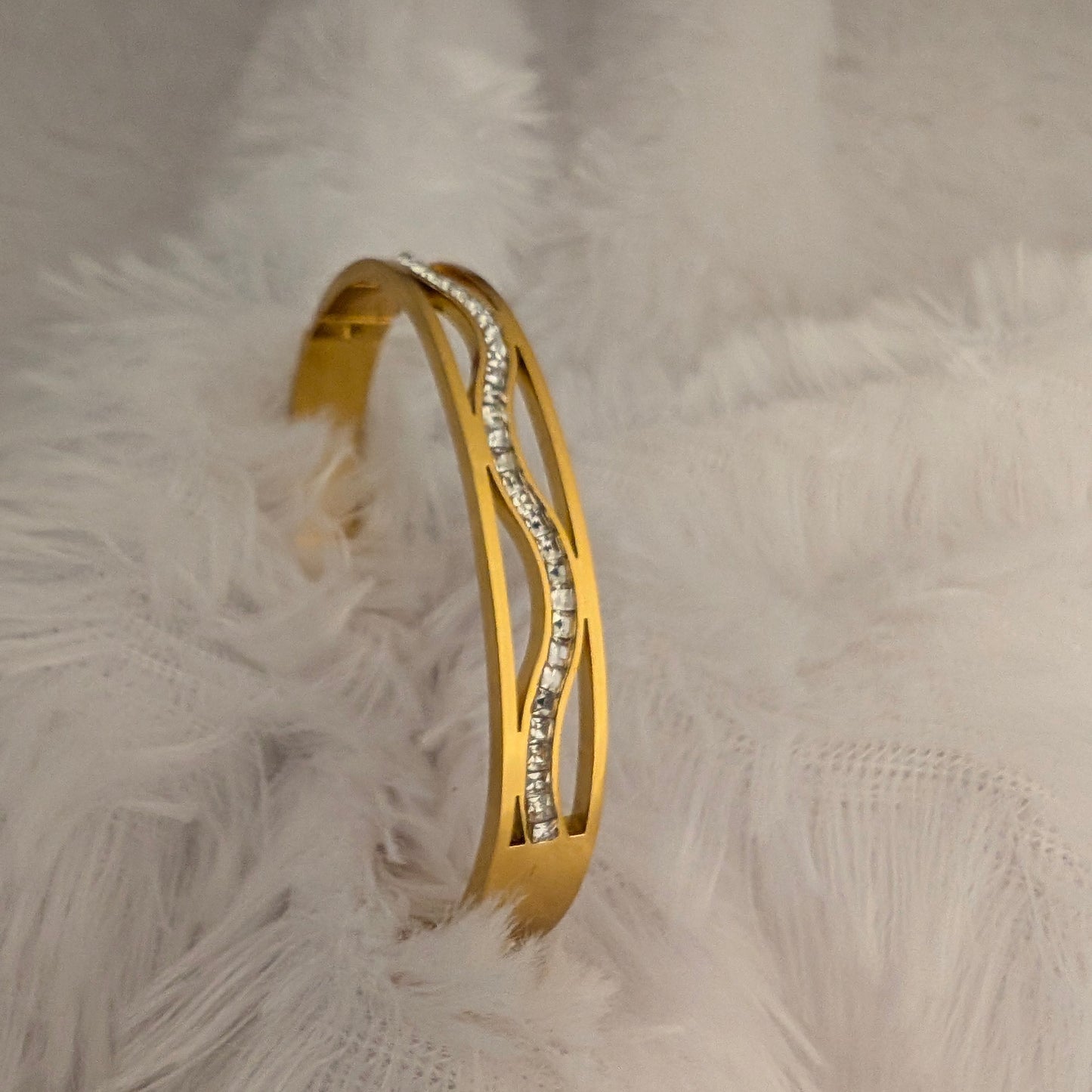 Gold bangle bracelet with embedded stones