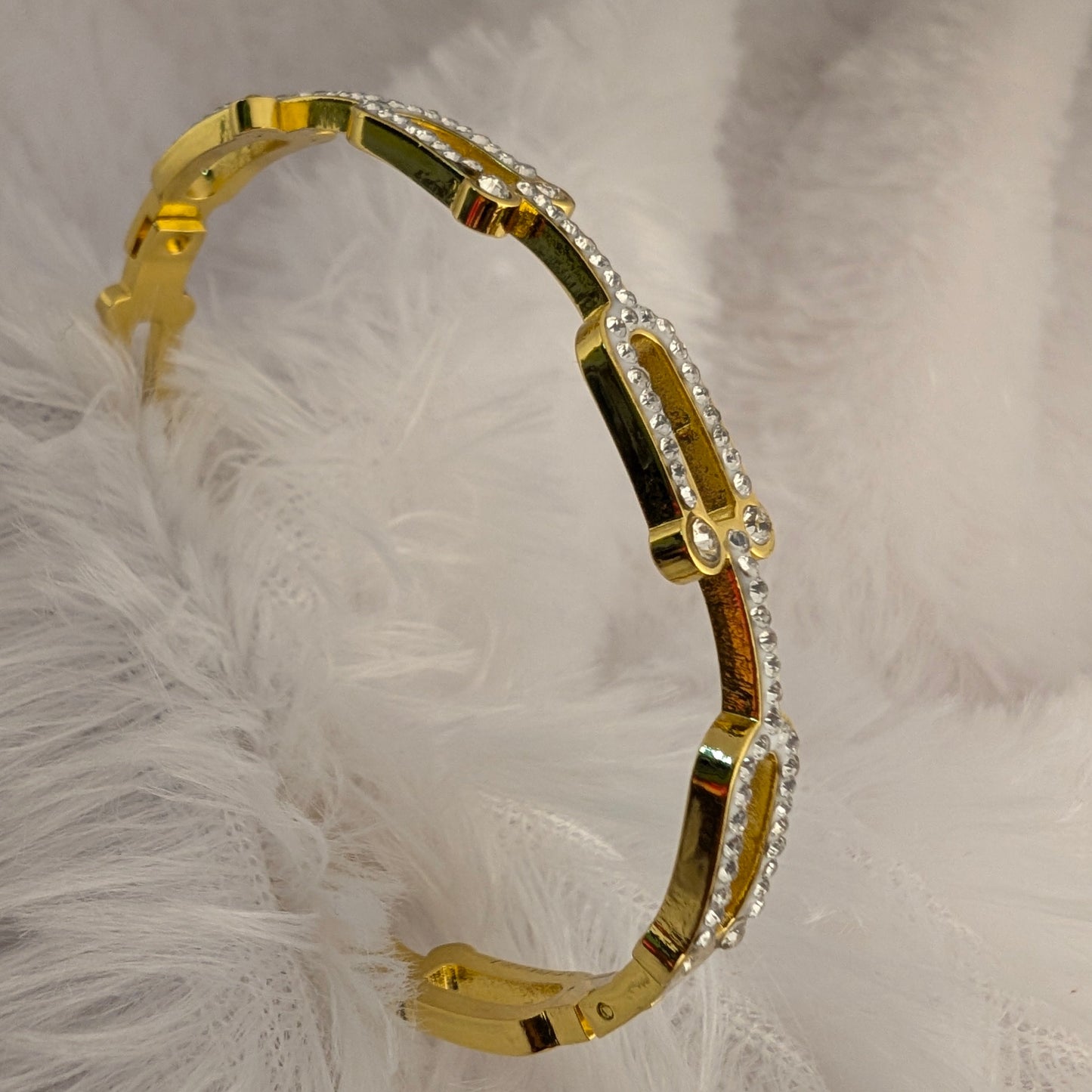 Gold bracelet with clear stones