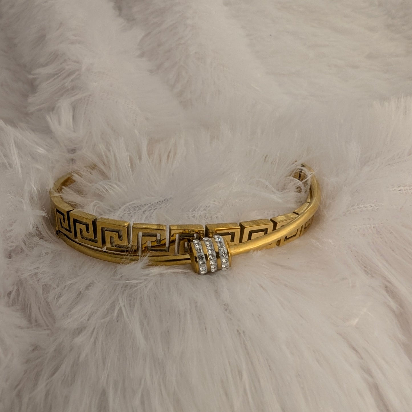 Gold bracelet with cross stone design elements