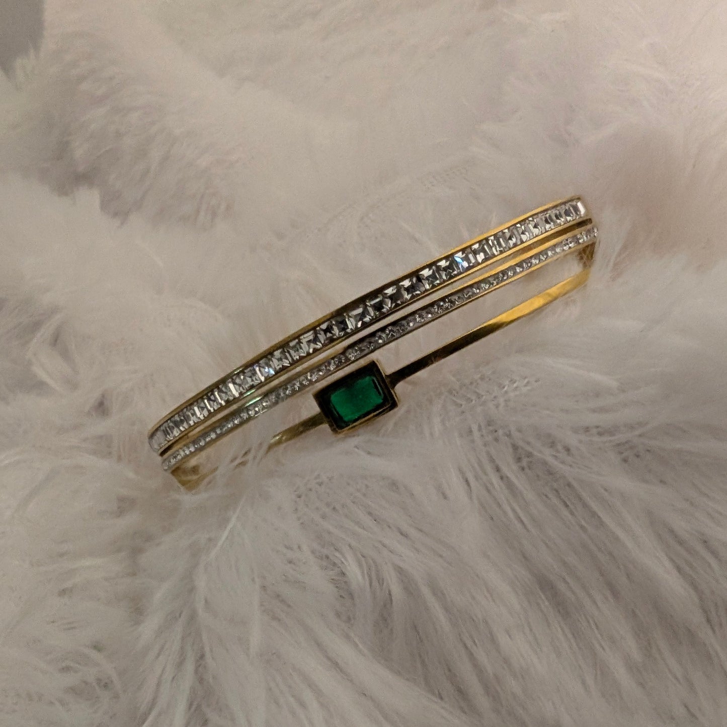 Gold bracelet with a green gemstone