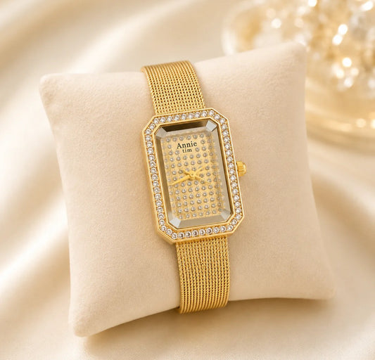 Gold-tone rectangular analog watch with a mesh band and crystal embellishments