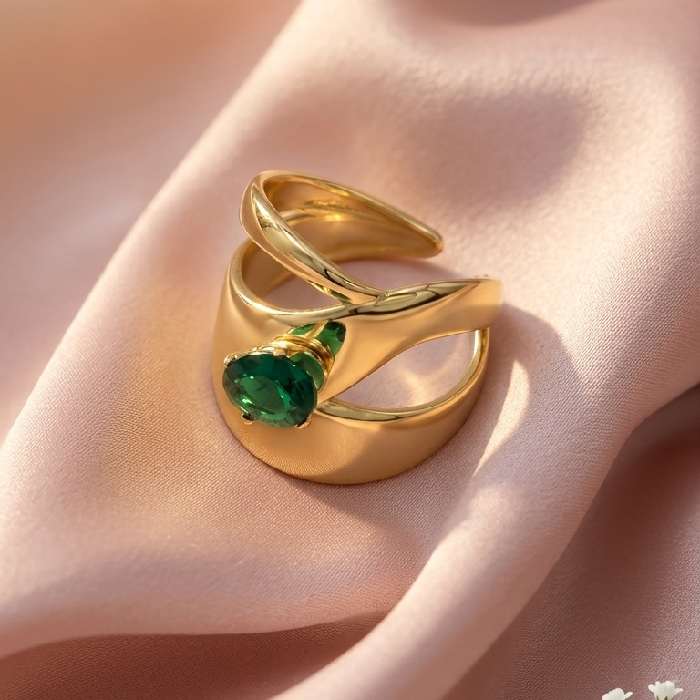 gold ring with a heart-shaped green gemstone