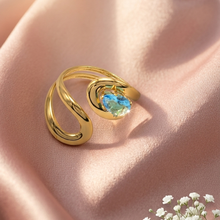 Gold ring with a twisted wrap design and blue oval Gemstone,