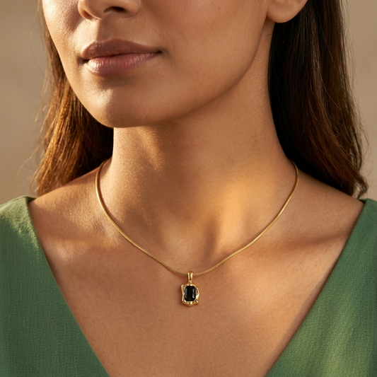  Gold chain necklace with a small rectangular pendant
