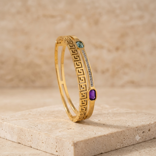 gold bracelet with blue and sea green emerald and white stones studded