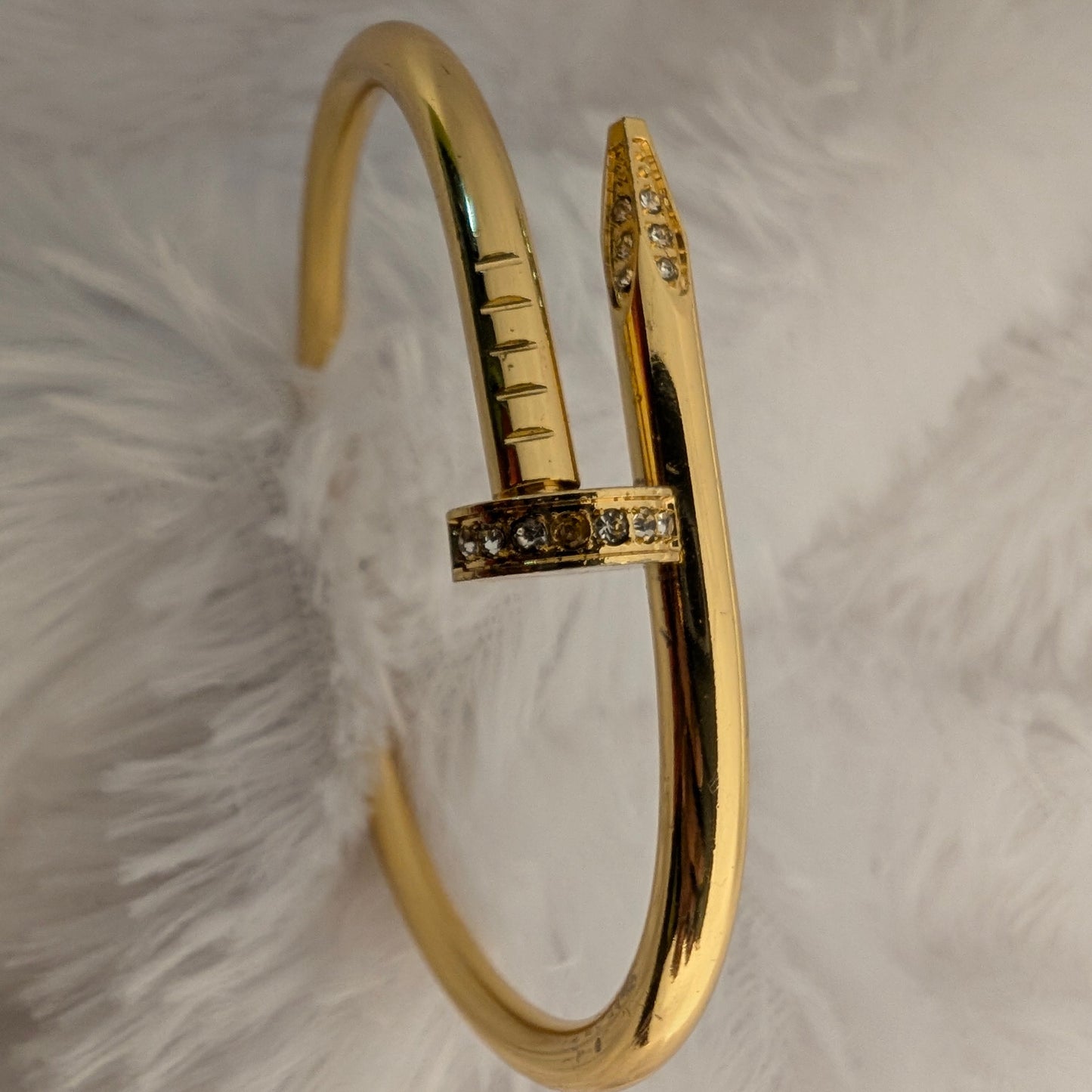 gold nail bracelet with stones