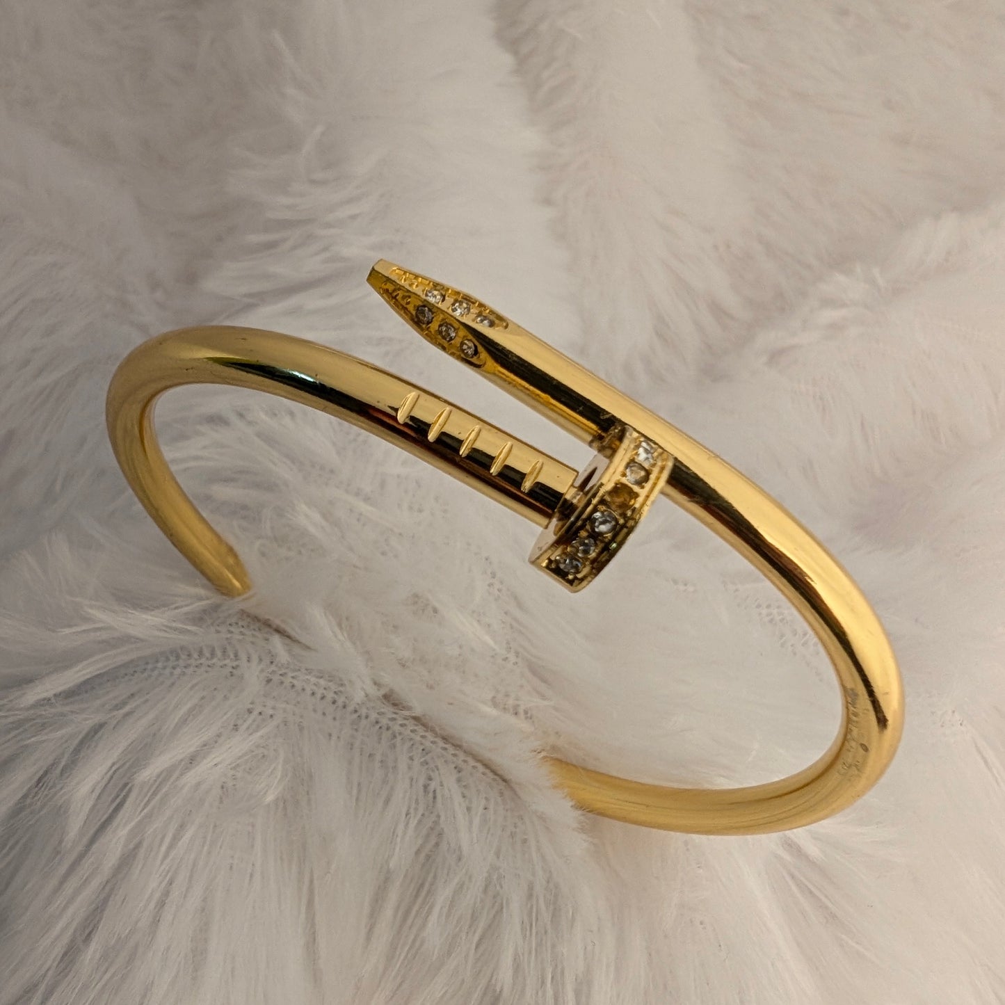 gold nail bracelet with stones
