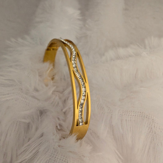 Gold bangle bracelet with embedded stones