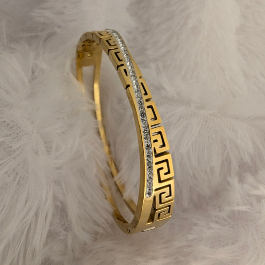 Gold bracelet with greek pattern and cross stones line