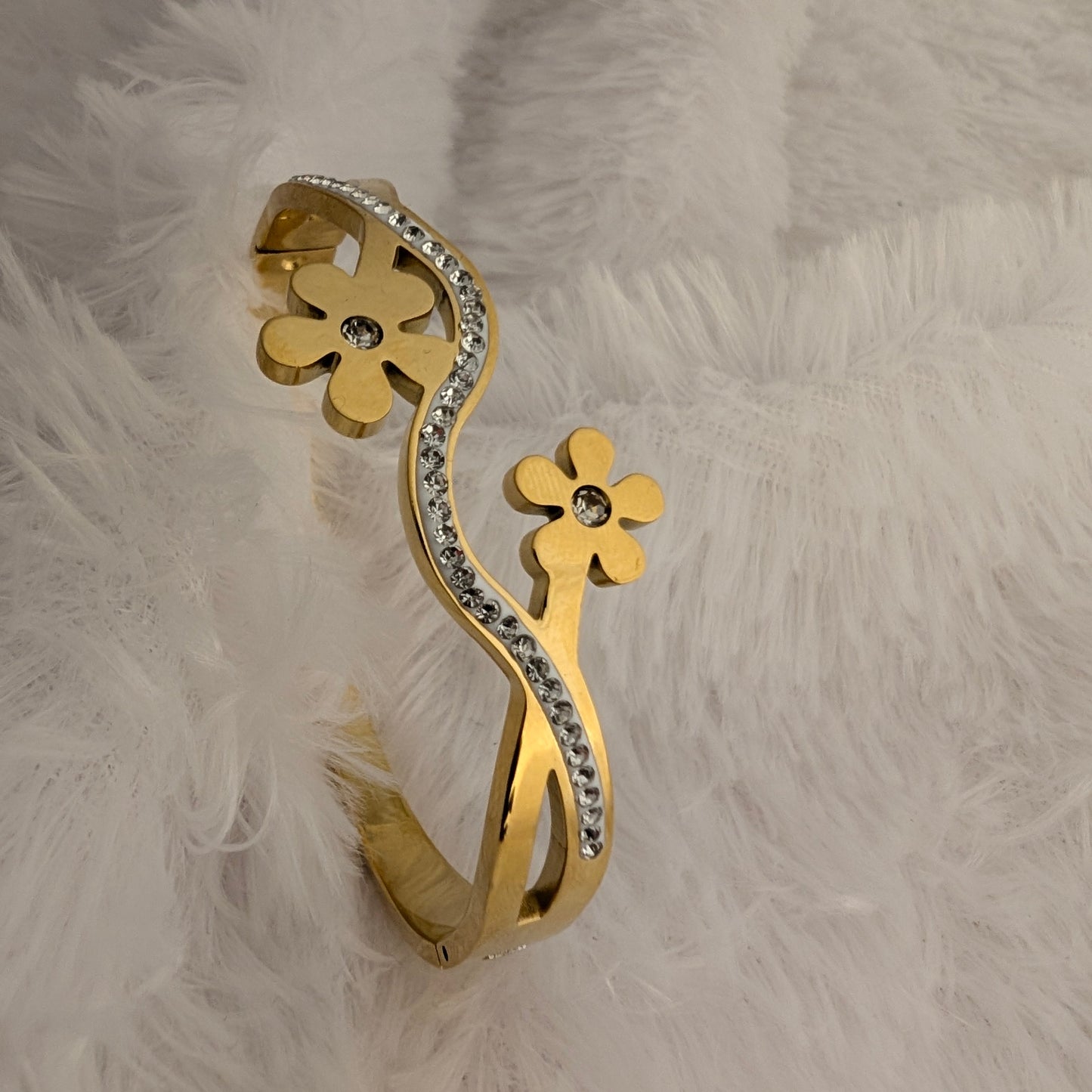 Gold bracelet with floral design and stones