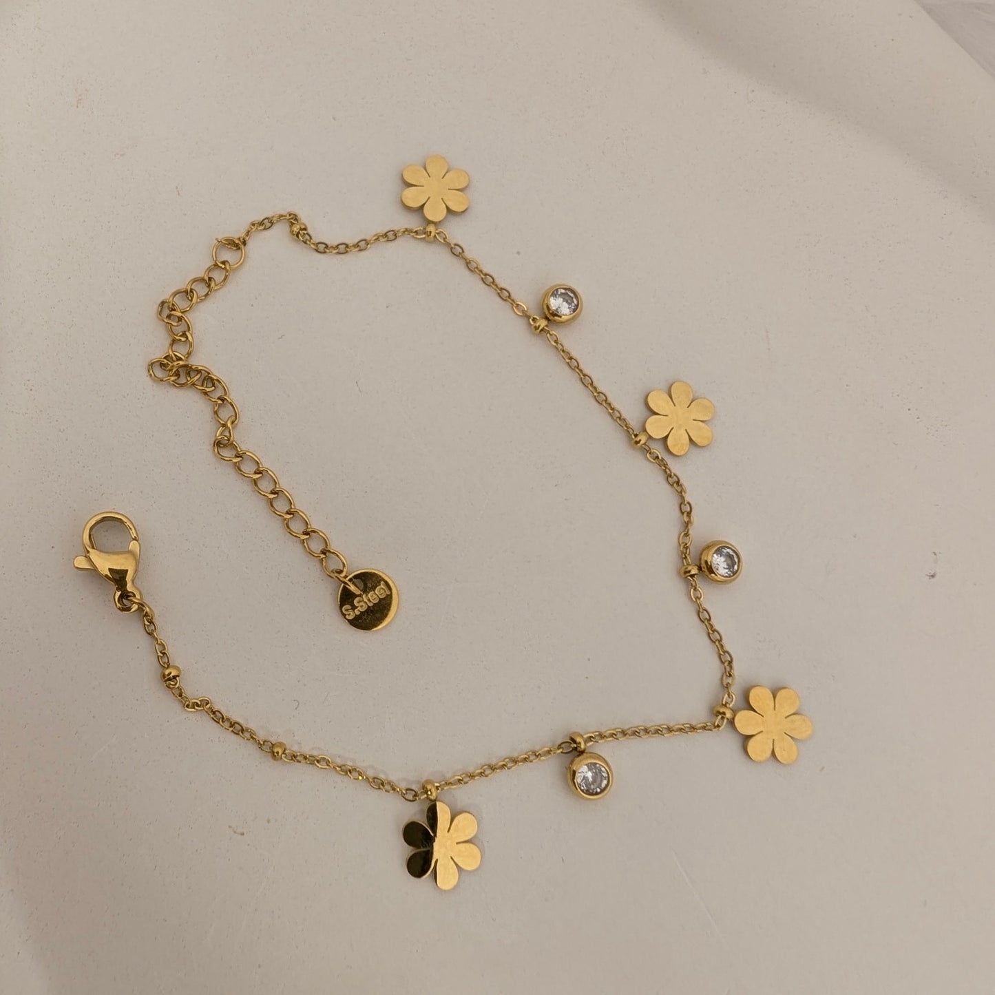 Gold bracelet with flower charms