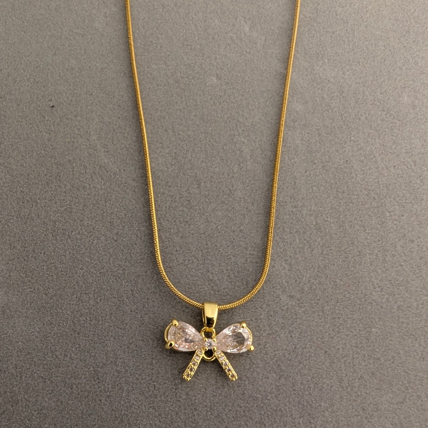 Gold necklace with a bow-shaped pendant
