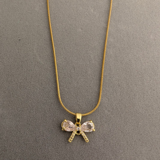 Gold necklace with a bow-shaped pendant