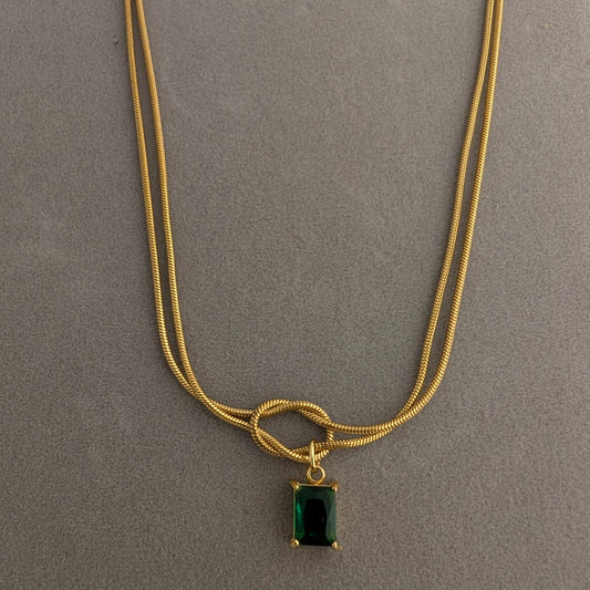 Gold necklace with a green gemstone pendant