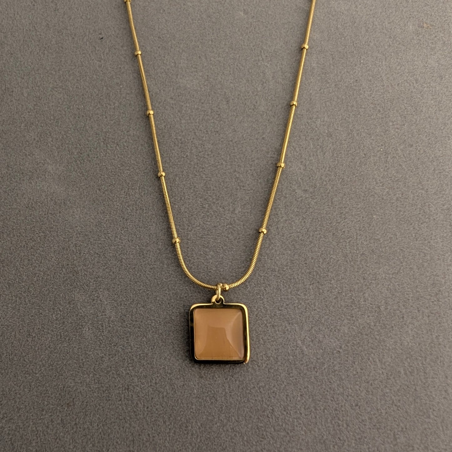 Gold necklace with a square pendant