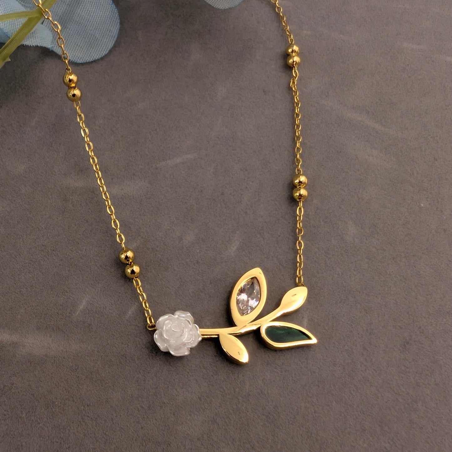 White 3d flower with green and white stone leaves